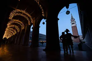 Couple in costume at St Mark’s Square at night